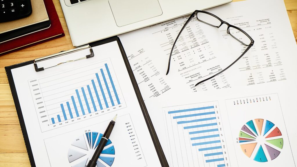 overhead view of charts, graphs, and financial paperwork on a desk
