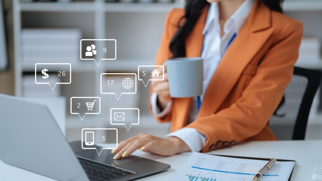 woman typing on a laptop with speech bubbles floating above it