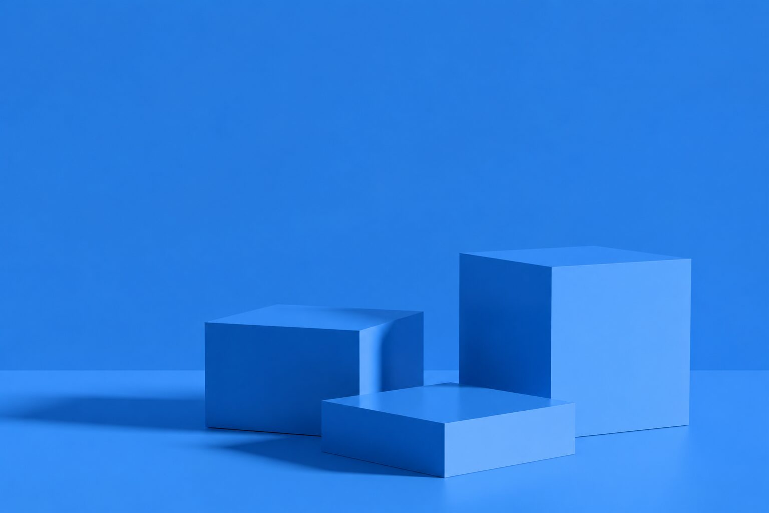 Minimalist abstract background with three blue rectangular podiums on a blue floor and wall.